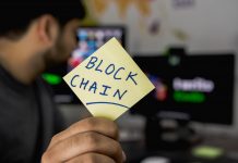 The Role of Blockchain Technology in Pharma Supply Chain Transparency person holding sticky note that says blockchain