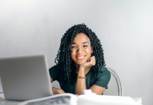 Navigating Regulatory Constraints in Pharma Advertising Woman smiling in front of laptop