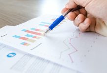 Predictive Analytics in Pharma: Trends and Use Cases Person looking at graphs with a pen