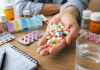 The Polypharmacy Problem: Why Your Next Prescription Feels Like One Too Many Patient holding multiple prescription pills beside medication bottles and a pill organizer, illustrating the challenges of polypharmacy and medication burden.