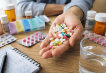 The Polypharmacy Problem: Why Your Next Prescription Feels Like One Too Many Patient holding multiple prescription pills beside medication bottles and a pill organizer, illustrating the challenges of polypharmacy and medication burden.
