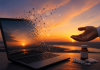 The Digital Sunset: How to Retire a Pharma Brand Without Leaving Patients Behind Laptop dissolving into digital assets at sunset beside pharmaceutical packaging, representing brand lifecycle operations and the responsible retirement of pharmaceutical digital ecosystems.