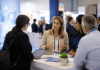The Hidden Decision-Makers Reshaping Pharma Success Pharma professionals and healthcare practice decision-makers discussing patient access and workflow strategies at a medical conference.