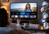 What Does a Pharma Campaign Look Like When Streaming Comes First? Patient watching streaming TV as part of an integrated connected TV pharma strategy across digital, search, audio, CRM, and HCP channels.
