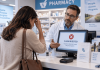 Your Patient Campaign Got the Click. Then the Pharmacy Claim Was Rejected. Now What? Patient discussing a rejected prescription claim with a pharmacist at the pharmacy counter.