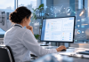 The EHR Is Becoming Programmatic Media. Pharma Buyers Should Pay Attention. Physician reviewing EHR data and connected programmatic healthcare advertising insights on a digital screen