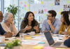 What If Patient Ambassadors Were Your Best Research Team? Diverse patient ambassadors and healthcare professionals collaborating in a research workshop to improve patient experiences and pharmaceutical marketing strategies.